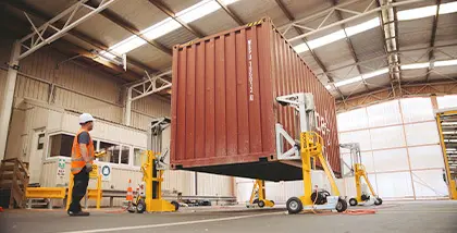 Container being moved inside a warehouse
